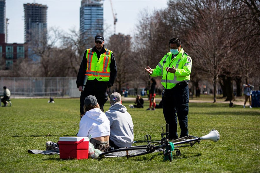 Bylaw officers ask a couple who can’t produce ID proving they live together to leave Trinity Bellwoods Park. Hanging out less than two metres from someone you don’t live with in a public park was against the rules in April.