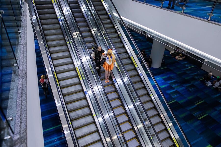 People in costume on an escalator at Fan Expo Canada 2021