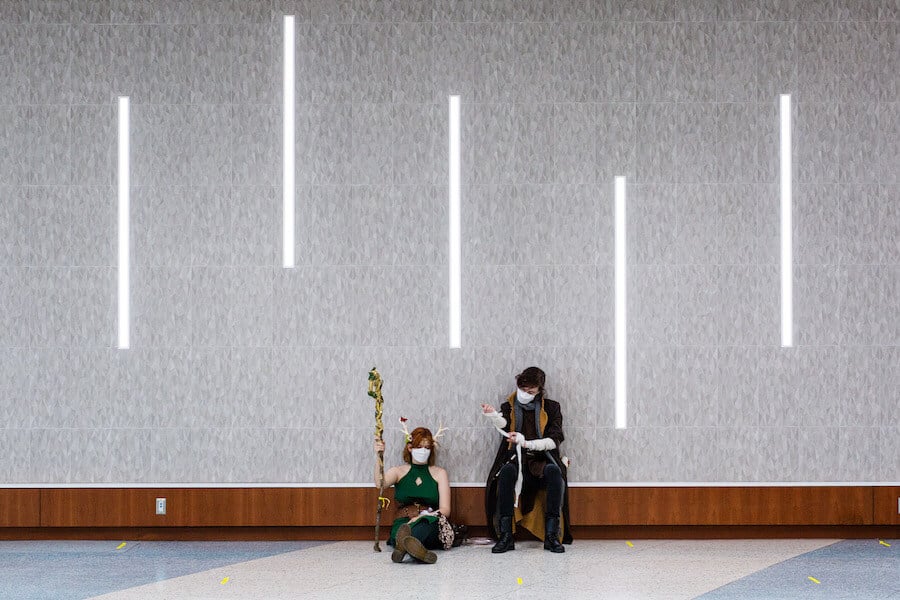 People in costume against a wall at Fan Expo Canada 2021