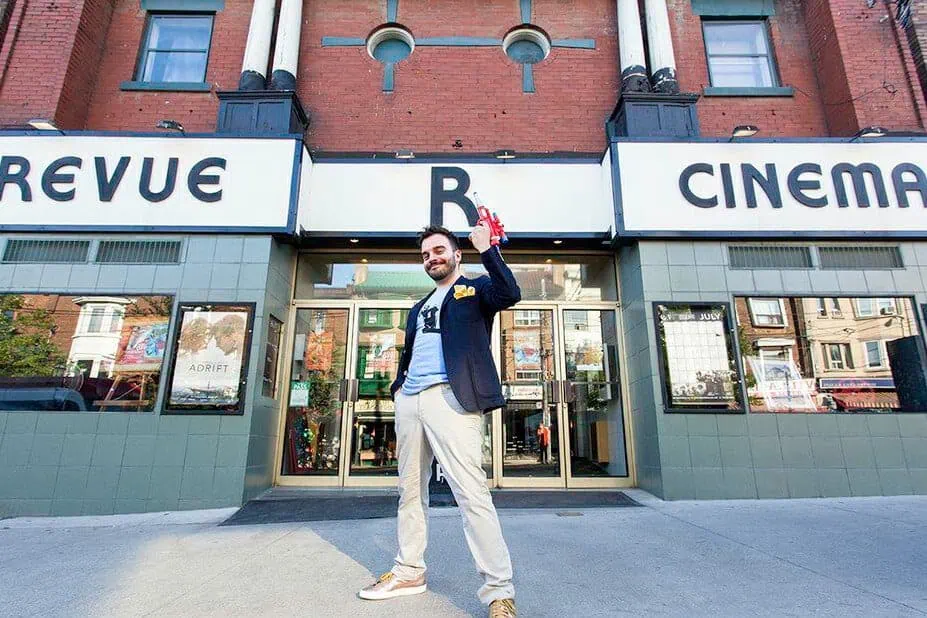 Anthony Oliveira poses in front of the Revue Cinema