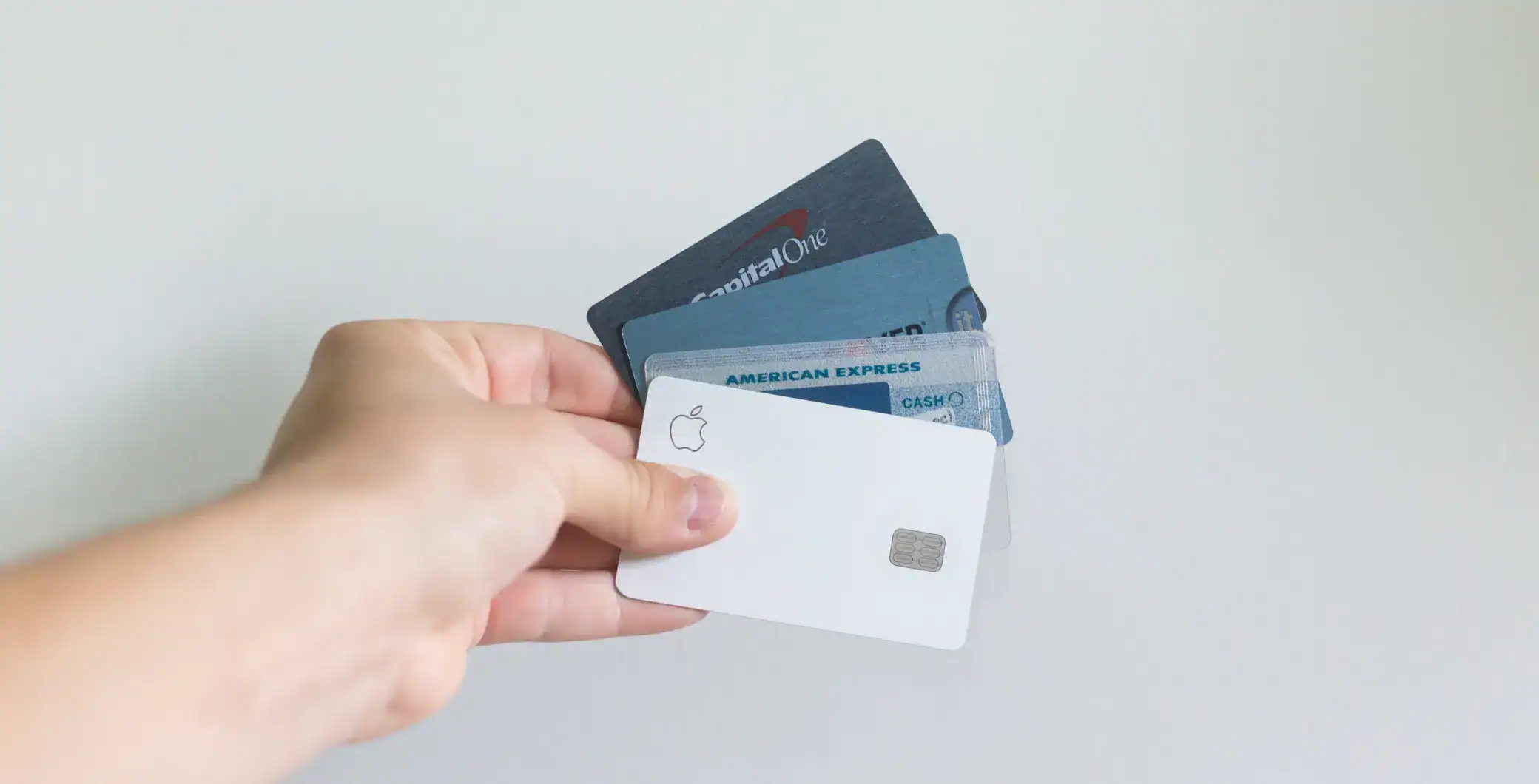 Credit card bundle including Apple Card, American Express, Capital One, and other credit cards on white background.