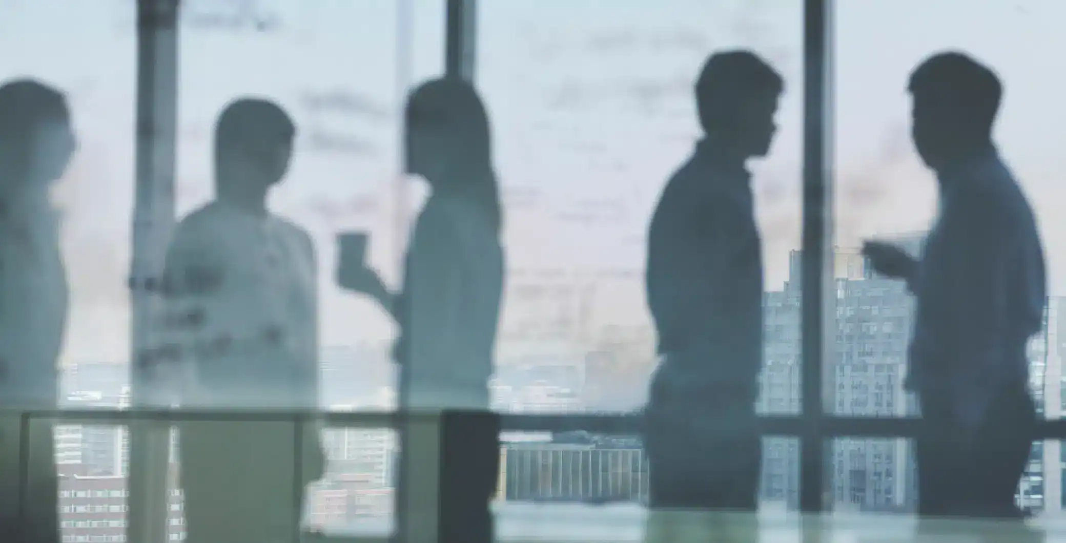 Professionals discussing in an office with city skyline view, team collaboration, business meeting, corporate workspace, urban environment, modern office setting, teamwork, office life, business professionals, cityscape in background.