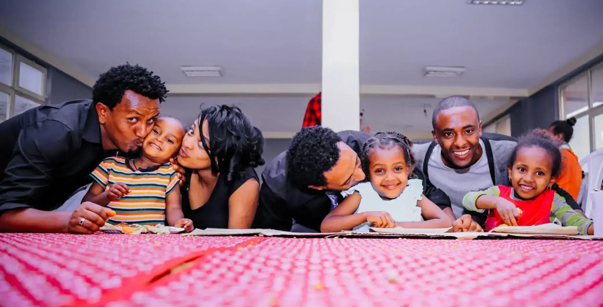 Smiling African Canadian family enjoying quality time together at a community event in Toronto, Canada, promoting family bonding and diverse Toronto culture.