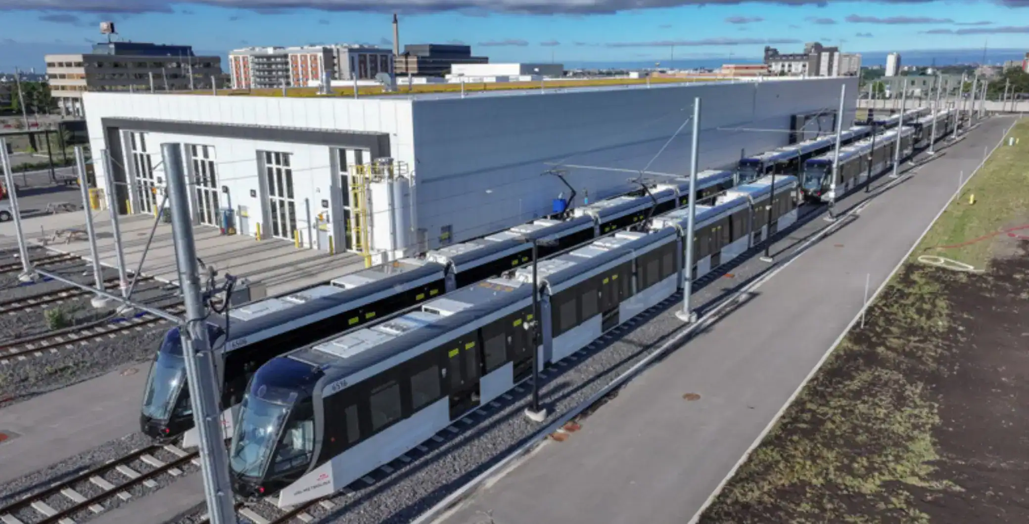 Modern Toronto streetcar on tracks near transit facility with surrounding cityscape, emphasizing Toronto public transportation and urban mobility.