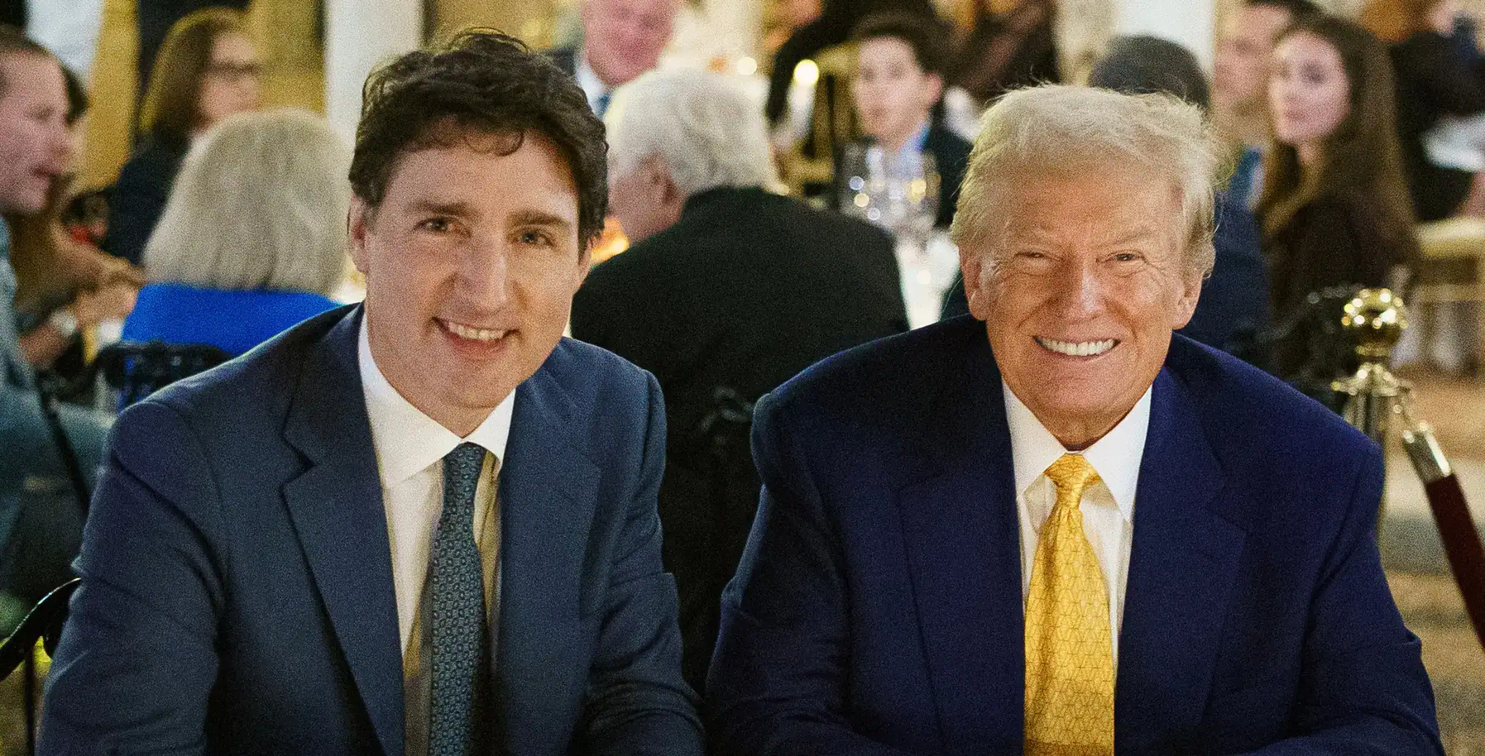 Justin Trudeau and Donald Trump smiling at a formal event in Toronto.