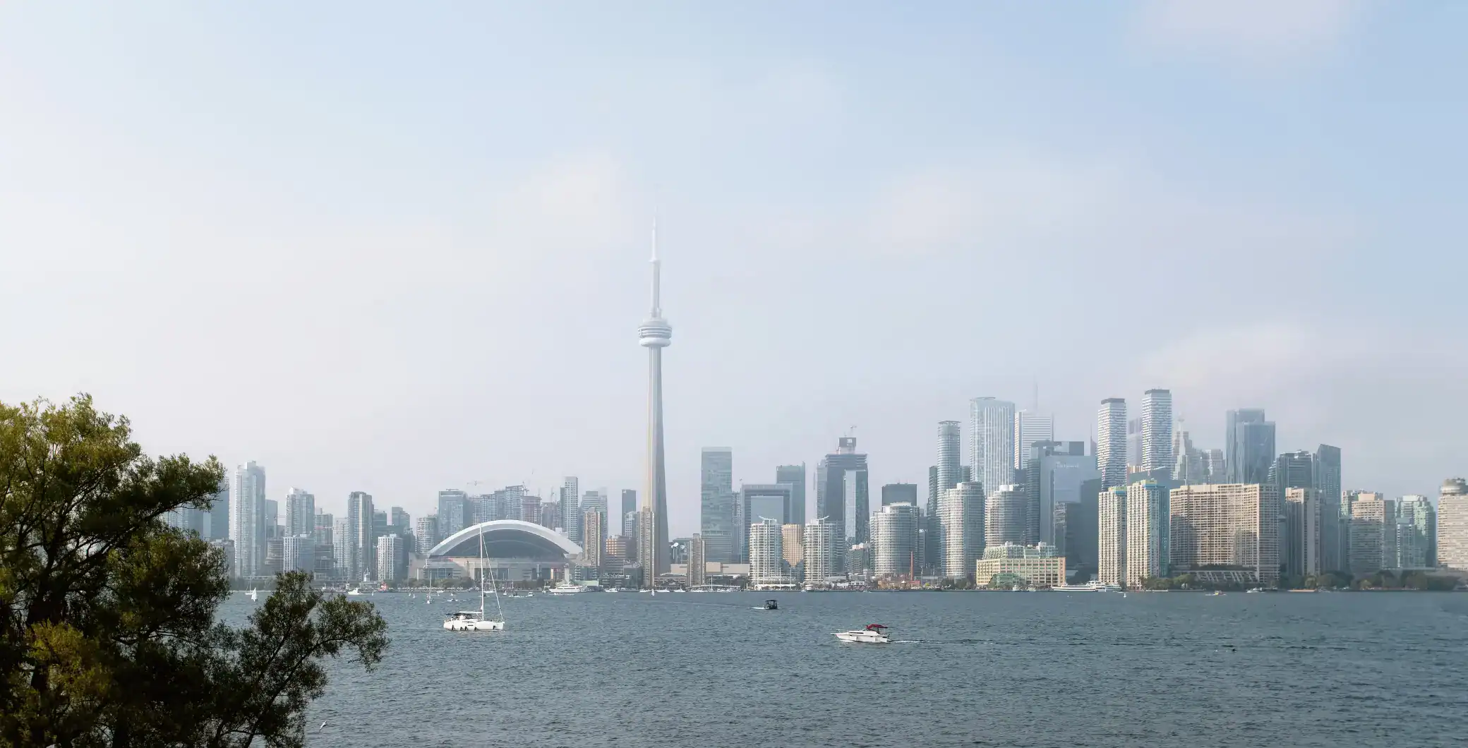 Skyscrapers and CN Tower skyline view of Toronto cityscape near Lake Ontario on a clear day.