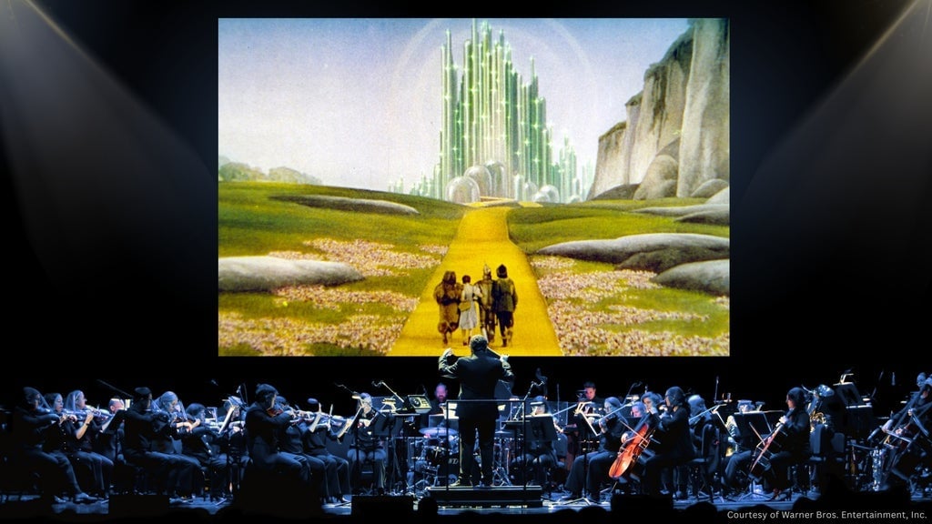 Toronto Symphony Orchestra live concert with a colorful digital landscape projection.