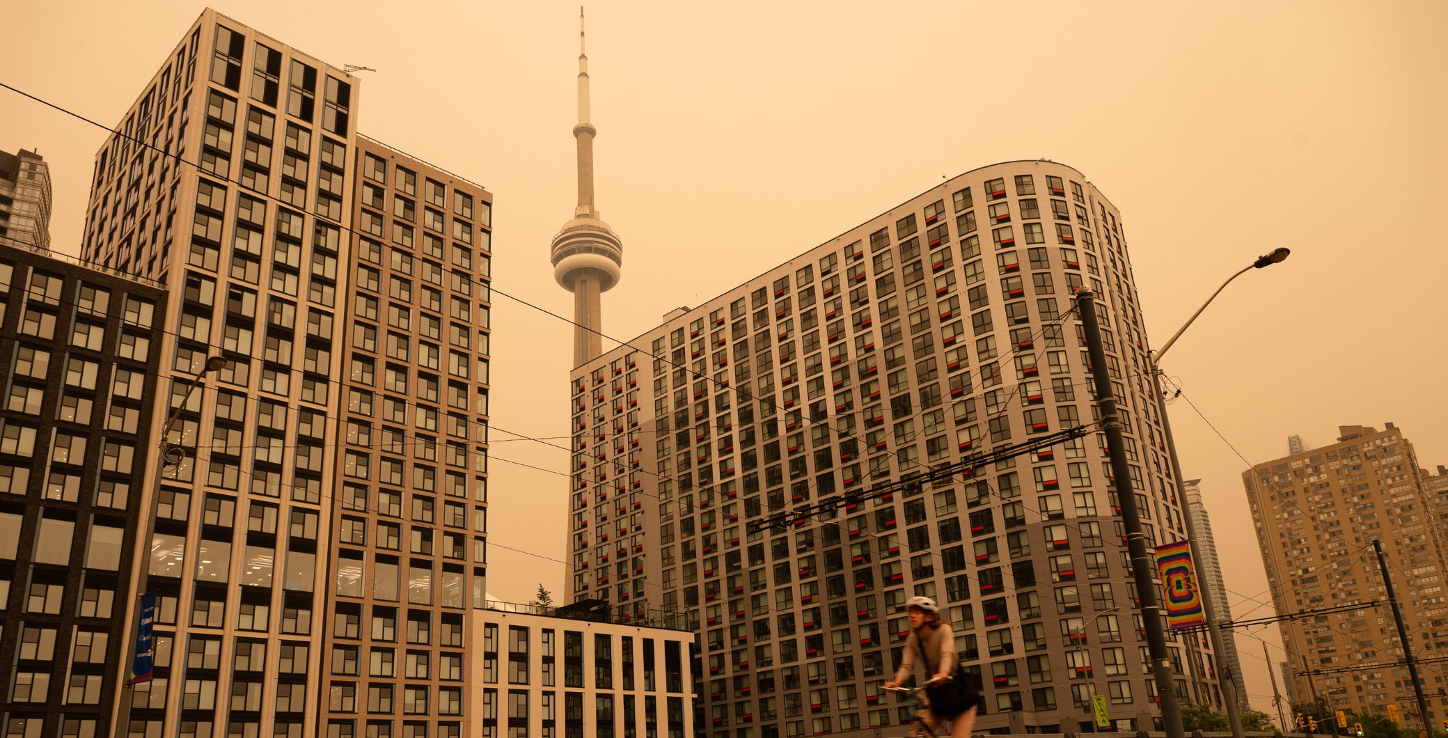 A woman bikes along the waterfront in Toronto as wildfire smoke fills the city, on Wednesday, July 15, 2026. THE CANADIAN PRESSLaura Proctor