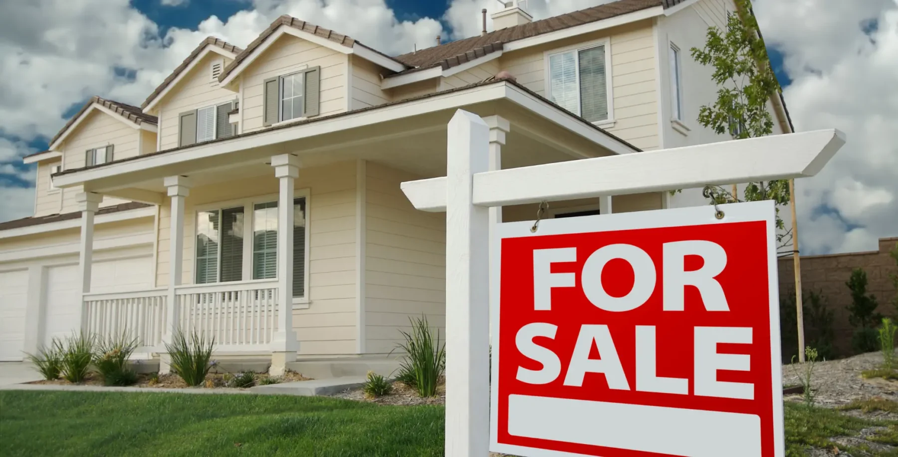 Beautiful suburban house with a 'For Sale' sign in front, showcasing Toronto's real estate market.