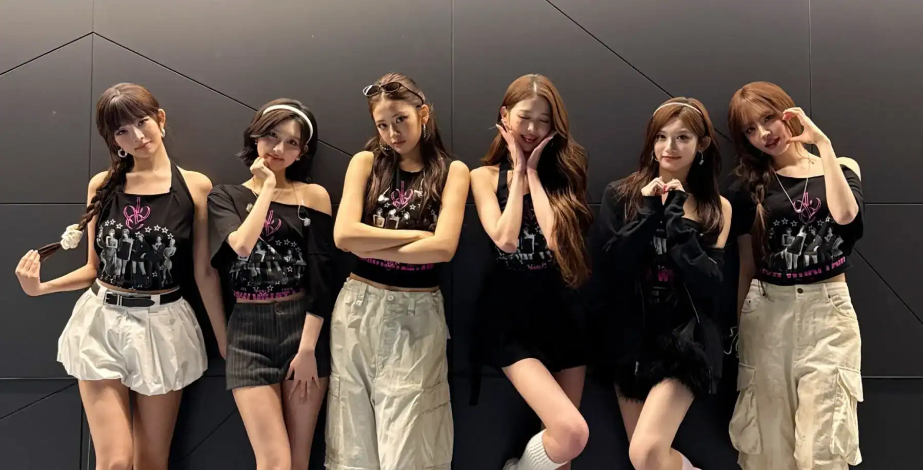 Six members of the K-pop girl group IVE posing together in stylish outfits at a fan event in Toronto.
