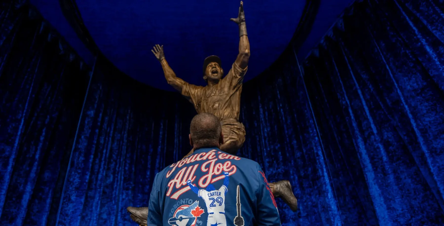 Blue Jays fans celebrate Joe Carter statue honoring his 1993 World Series-winning home run at Rogers Centre.