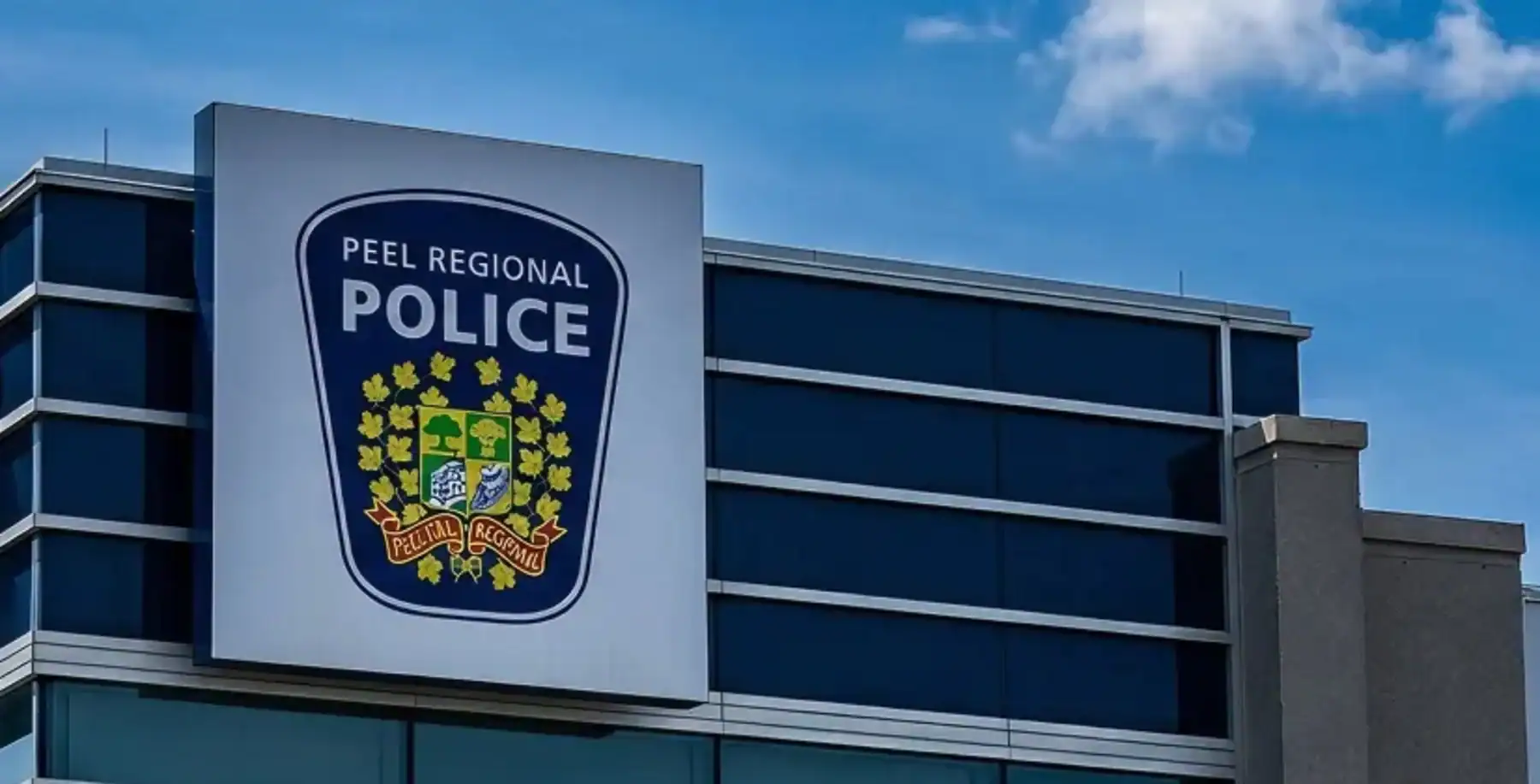 Peel Regional Police building with police badge logo on the facade in Mississauga, Ontario.