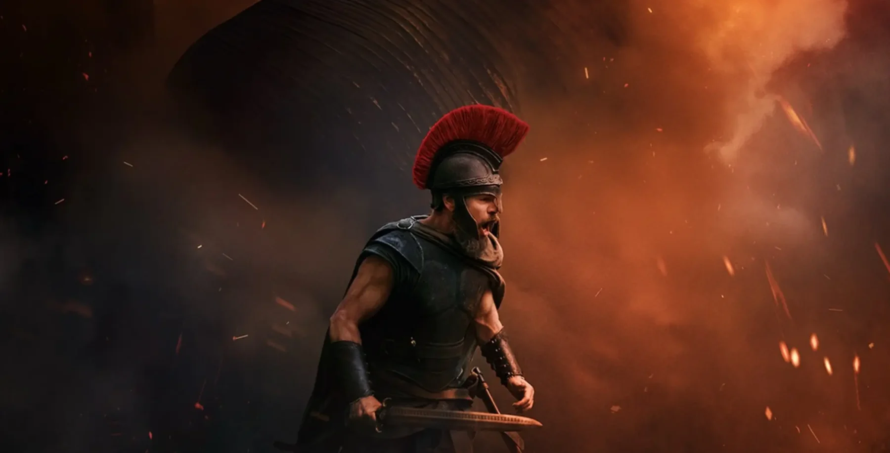 A warrior in armor with a red helmet stands amidst fiery explosions and smoke, creating a dramatic scene of battle or chaos.