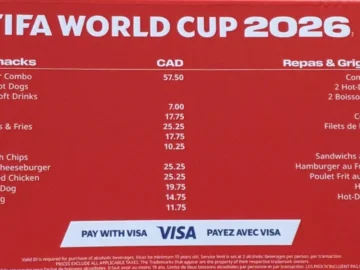 FIFA World Cup 2026 food and snack menu with prices, including hot dogs, fries, chicken tenders, and beverages, on a red background.